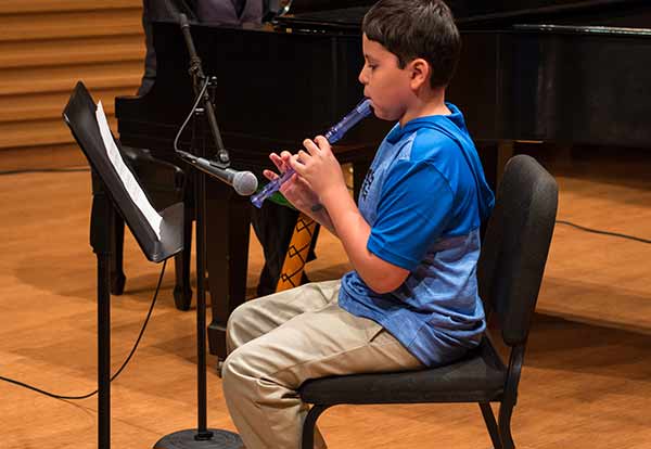 kid playing flute in music class tampa