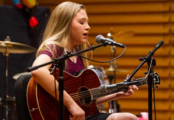 girl having guitar lessons